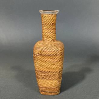 Glass bottle with shaped basket